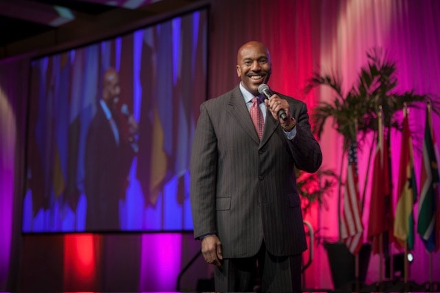 Roy Minter speaking on stage with microphone